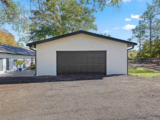 detached garage featuring fence