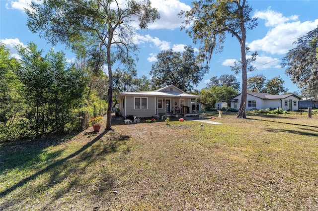 exterior space with covered porch and a front lawn