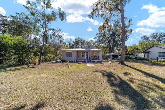 view of front facade with covered porch and a front yard