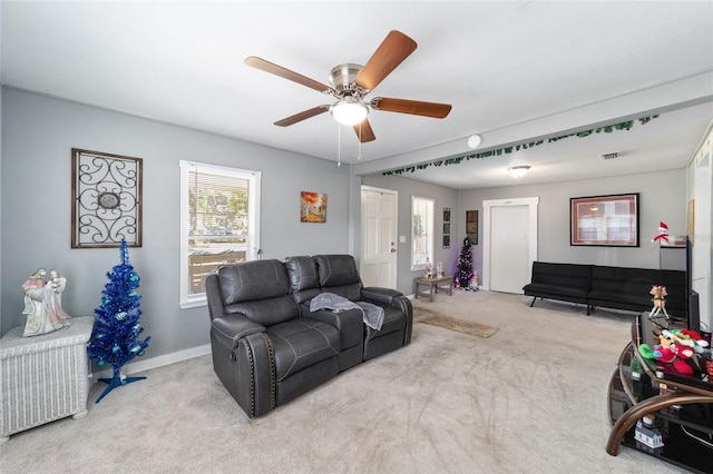 living room with light colored carpet and ceiling fan