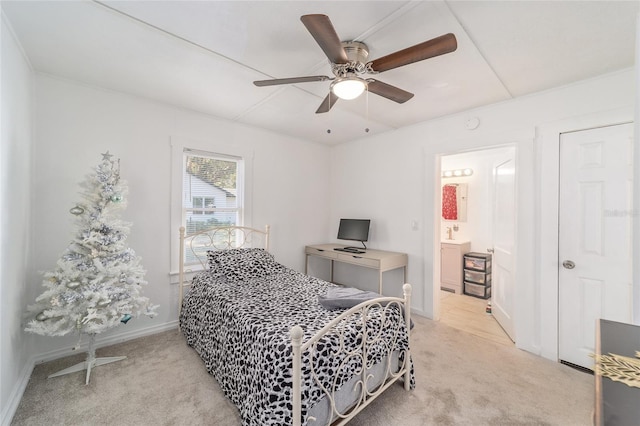 carpeted bedroom with ceiling fan and ensuite bathroom