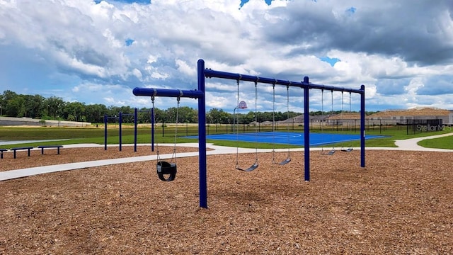 view of jungle gym featuring basketball hoop