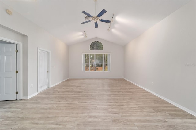 empty room featuring ceiling fan, rail lighting, light hardwood / wood-style floors, and lofted ceiling