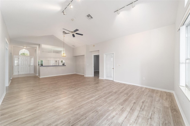 unfurnished living room with ceiling fan, track lighting, light hardwood / wood-style floors, and vaulted ceiling