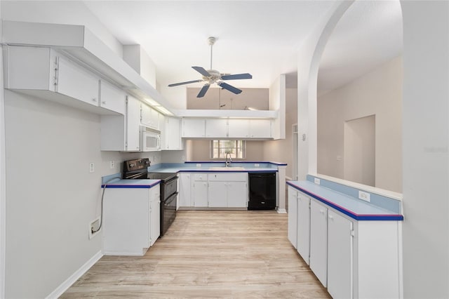 kitchen with black appliances, white cabinets, sink, ceiling fan, and light hardwood / wood-style floors