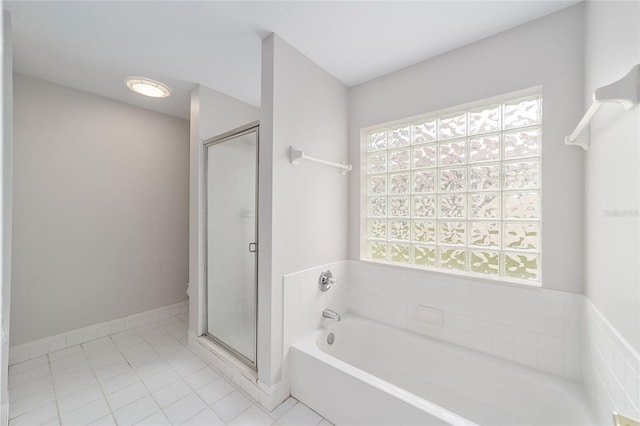 bathroom with shower with separate bathtub and tile patterned floors