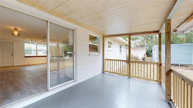 unfurnished sunroom featuring wooden ceiling