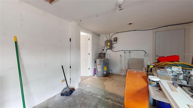 garage with electric panel and water heater