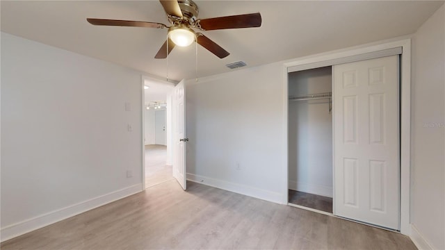 unfurnished bedroom with ceiling fan, a closet, and light hardwood / wood-style flooring