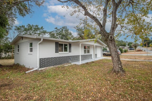 view of property exterior featuring a yard and a garage