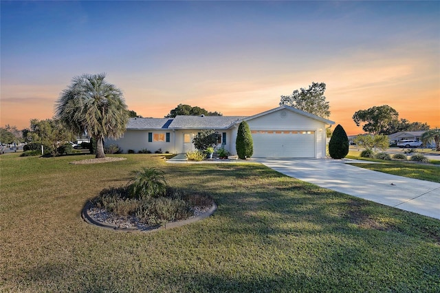 ranch-style home with a lawn and a garage