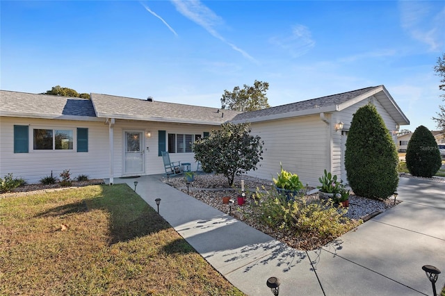 ranch-style home with a front yard