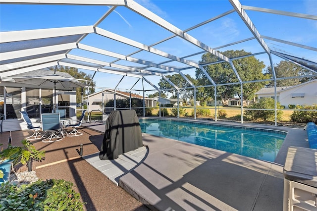 view of swimming pool featuring a patio and a lanai