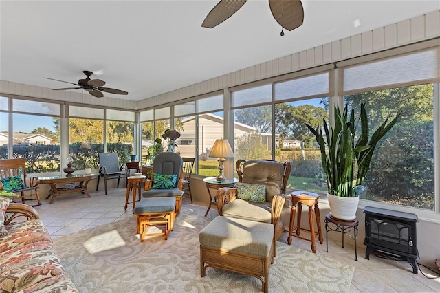 sunroom / solarium with plenty of natural light and a wood stove