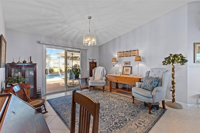 sitting room with an inviting chandelier, light tile patterned floors, a textured ceiling, and vaulted ceiling