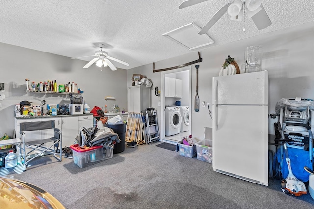 miscellaneous room featuring washer and dryer, carpet floors, and a textured ceiling