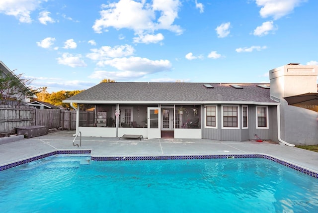 view of pool with a sunroom and a patio