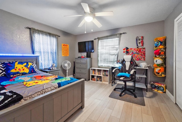 bedroom with ceiling fan and light hardwood / wood-style floors