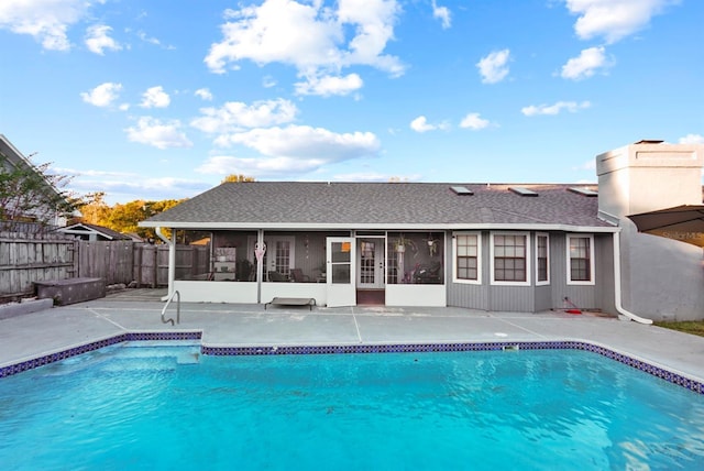 view of pool featuring a patio, a fenced backyard, a sunroom, and a fenced in pool