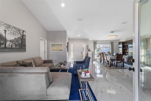 living room with vaulted ceiling and a notable chandelier