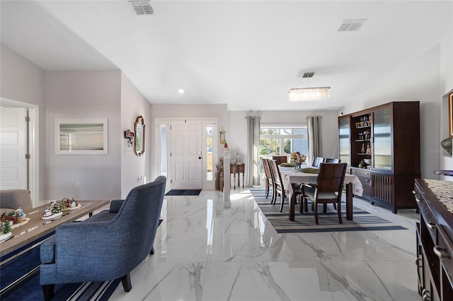 dining area with an inviting chandelier