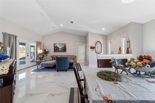 dining area featuring french doors and vaulted ceiling