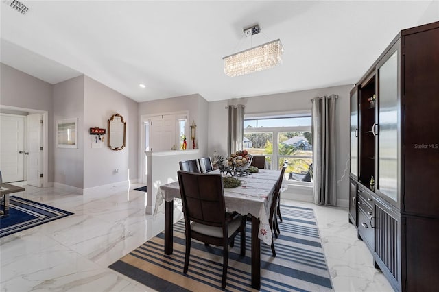 dining area featuring an inviting chandelier and vaulted ceiling