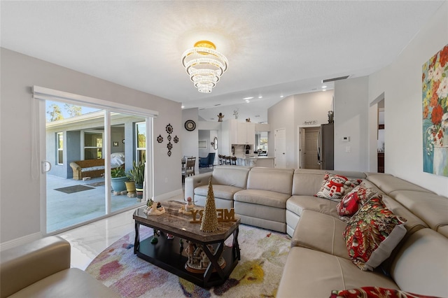 living room featuring a chandelier and lofted ceiling