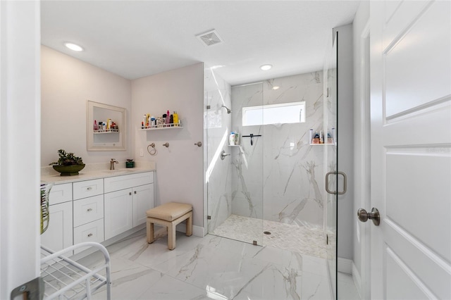 bathroom with vanity and a shower with shower door