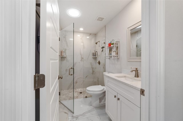 bathroom featuring vanity, toilet, and a shower with shower door