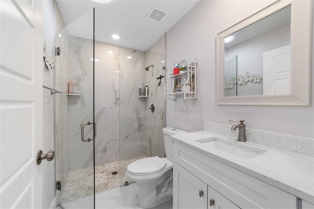 bathroom with vanity, toilet, and a shower with shower door