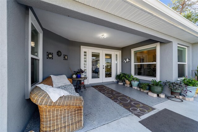 view of exterior entry featuring french doors