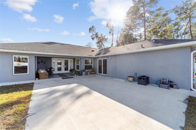 rear view of property with a patio area and french doors