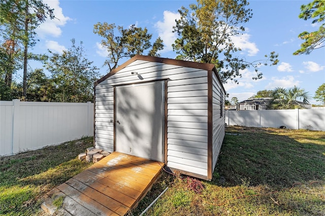 view of outdoor structure featuring a lawn