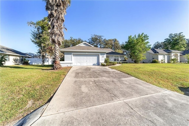 ranch-style house featuring a front yard and a garage