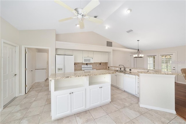 kitchen with a kitchen island, pendant lighting, and white appliances