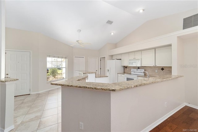 kitchen featuring kitchen peninsula, white appliances, vaulted ceiling, ceiling fan, and light hardwood / wood-style floors