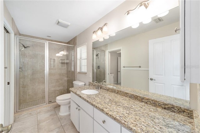 bathroom with tile patterned floors, vanity, toilet, and a shower with shower door