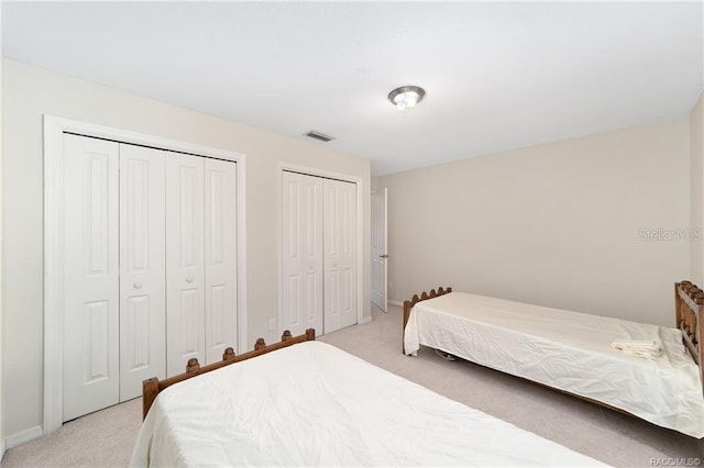 carpeted bedroom with two closets