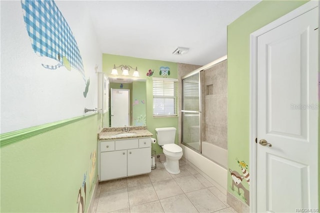 full bathroom with tile patterned floors, vanity, toilet, and shower / bath combination with glass door