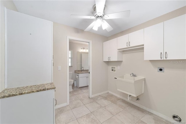 washroom featuring cabinets, hookup for a washing machine, ceiling fan, electric dryer hookup, and sink