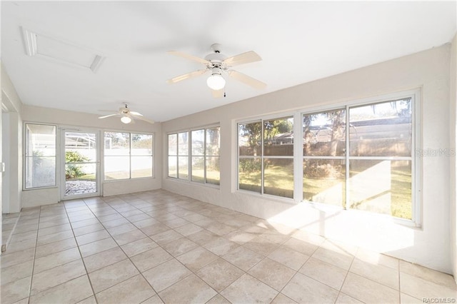 unfurnished sunroom featuring ceiling fan