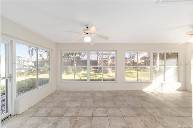 unfurnished sunroom featuring ceiling fan