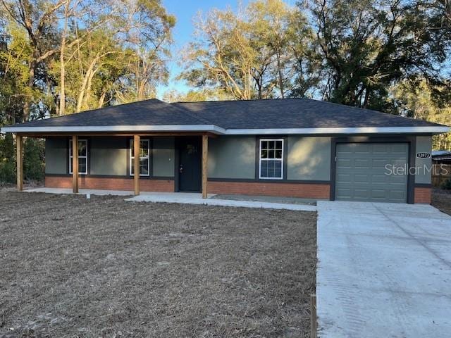 single story home featuring a porch and a garage