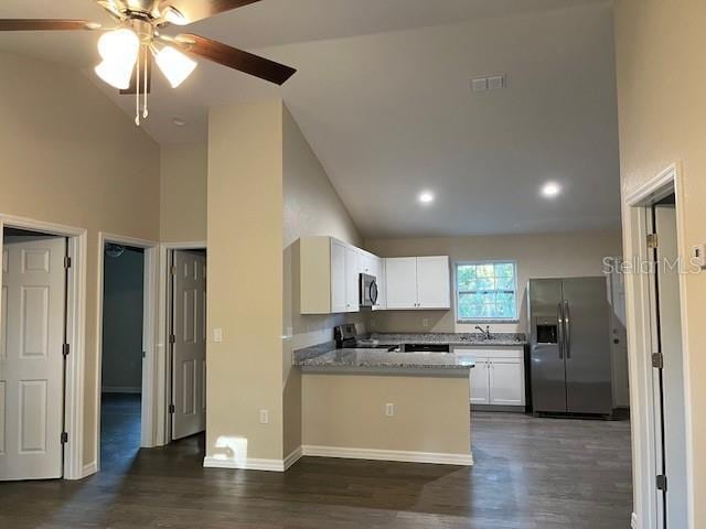 kitchen featuring appliances with stainless steel finishes, dark hardwood / wood-style floors, white cabinetry, kitchen peninsula, and light stone countertops