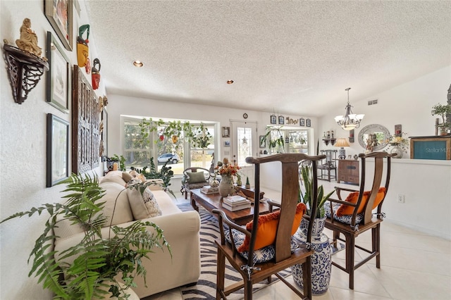 dining space with a notable chandelier, light tile patterned flooring, lofted ceiling, and a textured ceiling