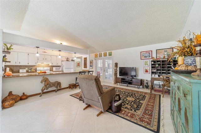 living room with a textured ceiling, french doors, light tile patterned floors, and lofted ceiling