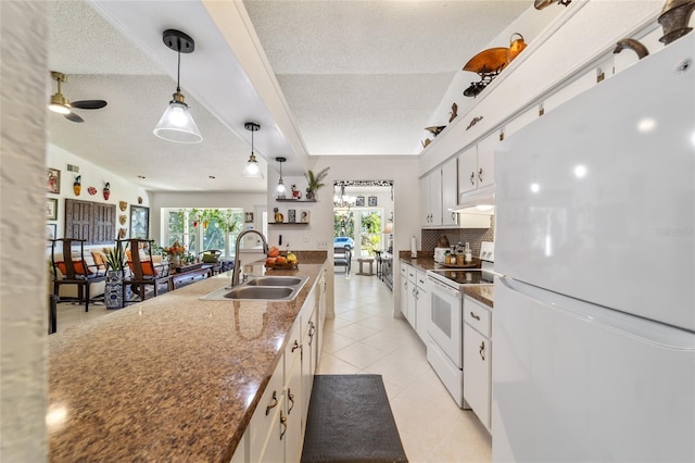 kitchen with a textured ceiling, white appliances, decorative light fixtures, and white cabinetry