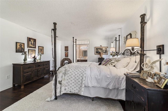 bedroom featuring a textured ceiling and dark wood-type flooring