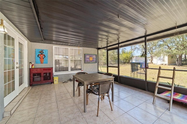 sunroom / solarium with french doors and a healthy amount of sunlight